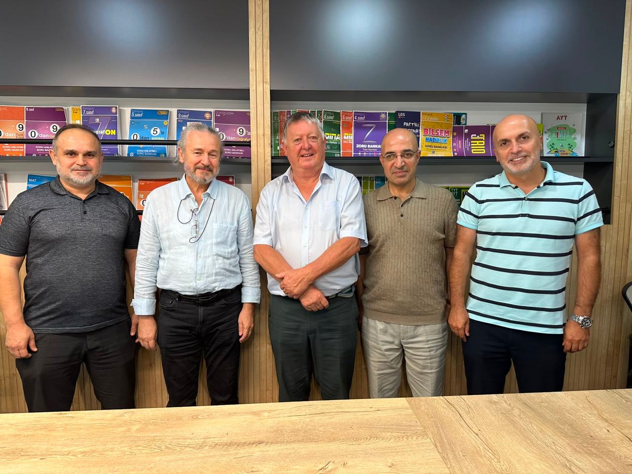 The Kibo Index team with a sector representative in front of book shelves